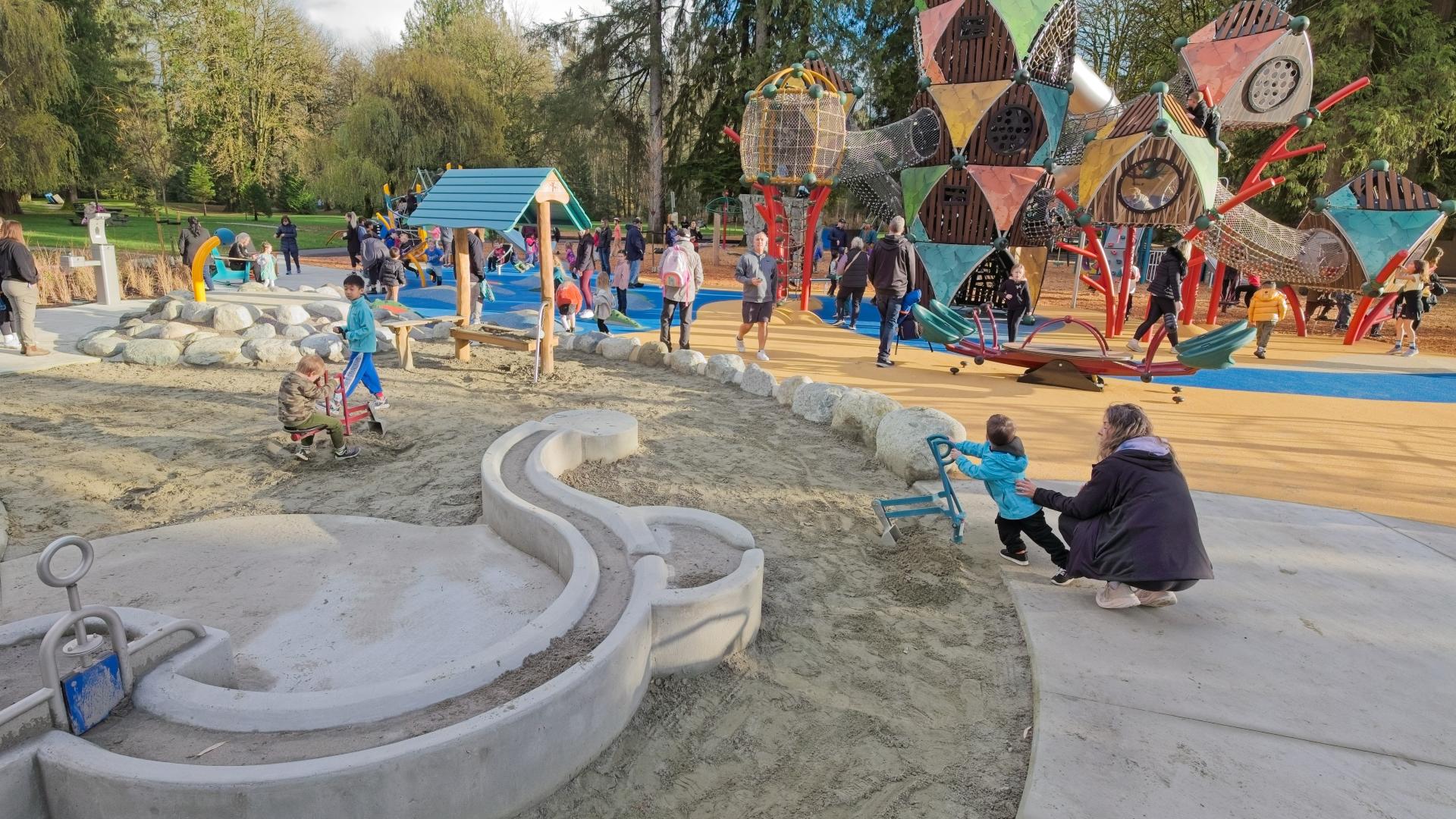 Large sand and water play area in front of new adventure playground